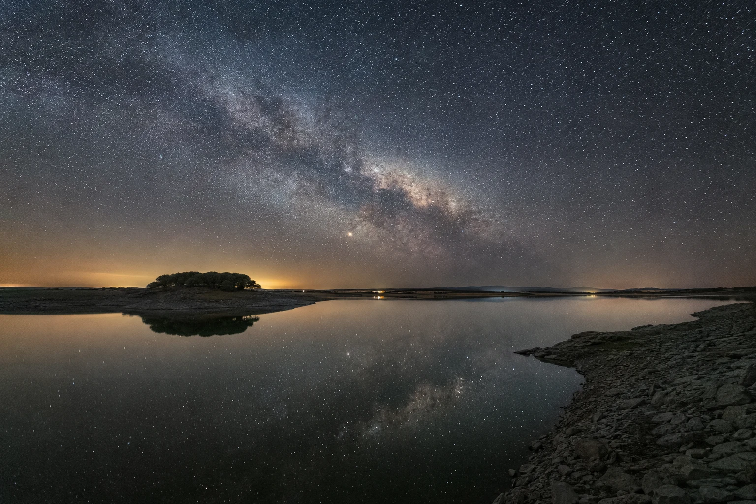 Alqueva reservoir under a clear starry sky